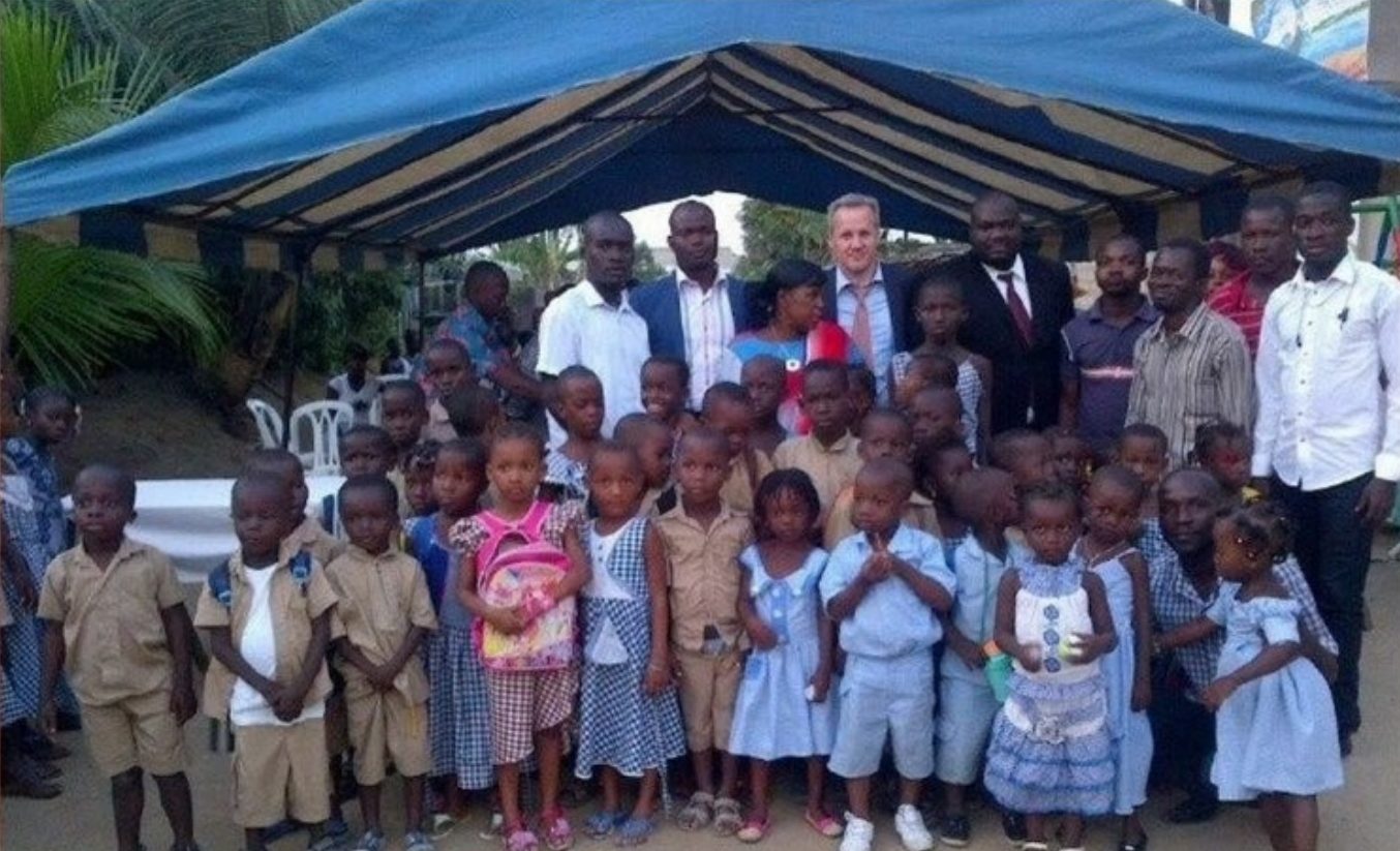 Elephant Oil representatives with schoolchildren at a supplies donation